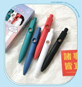 Close-up of colorful portable pocket pens with motivational text windows on white paper.
