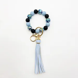Macro detail showing UV plated zebra stripe beads and a soft tassel on the keychain