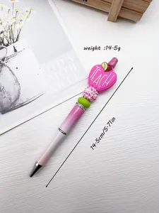 Detail view of TEACH apple charm and sparkly beads on the pink beaded pen