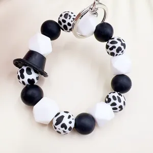 Portachiavi in perline di silicone stile cowboy con motivo mucca e perle nere