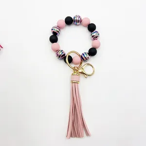 Detailed view of UV-coated zebra pattern beads and pink leather tassel keychain