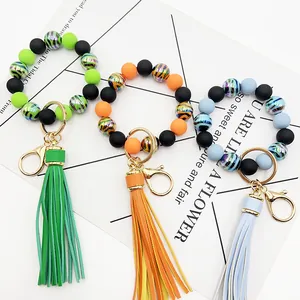 Close-up of UV plated zebra stripe beads and leather tassels on three colorful keychains