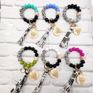 Western style cow print silicone bead keychain featuring yak wood charm and stylish tassel