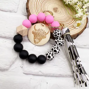 Western style cow print silicone bead keychain with engraved Highland cow wood disc
