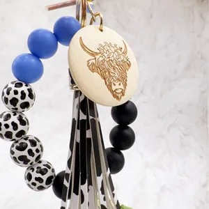 Western style highland cow keychain with colorful silicone beads and cow print tassel