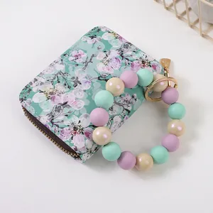 Blumenmuster-Geldbörse mit buntem Silikon-Perlenarmband-Schlüsselanhänger