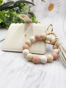 Macro view of matte silicone beads and PU leather card holder with an elegant tassel