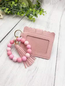 Detail view of pink PU leather card holder and silicone bead wristlet keychain set.
