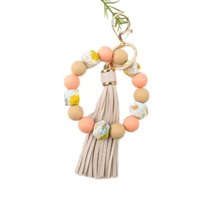 Pastel floral printed 14mm silicone bead bracelet keychain with an elegant leather tassel