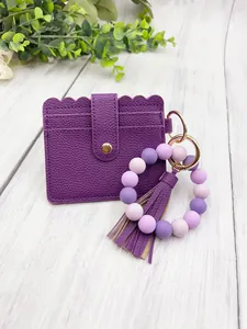 Purple PU leather card holder with matching silicone bead keychain and tassel detail.