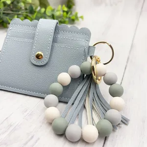 Elegant blue PU leather card holder featuring a colorful silicone bead bracelet and tassel keychain