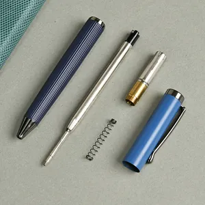 High-grade blue metal ballpoint pen disassembled showing internal components and refill.