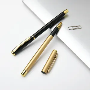 Professional elegant gold and black metal rollerball pens set on silver office laptop