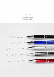 Close-up of multicolored metal ballpoint pens showing smooth ink flow on paper