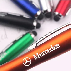 Detailed close-up of a metallic stylus ballpoint pen featuring a custom engraved brand logo