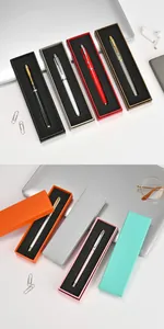 Variety of colorful metal pens in matching gift boxes on a modern office desk.