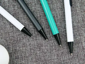 Macro detail of metal retractable pen tips in various colors on fabric background