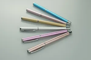 Detail view of colorful metal business pens in a fan-shaped arrangement with metallic finish.