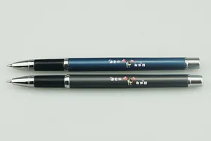 Close-up detail of blue and grey metal signature pens with romantic heart illustrations