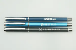 Close-up of three custom metal business pens in blue and grey with printed logos