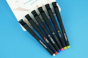 Detailed view of black customizable gel pens featuring integrated phone holder caps and logos