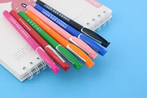 Detailed close-up of rainbow multi-color customizable gel pens on a spiral notebook