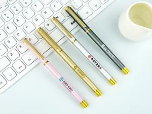 Detailed view of four premium metallic business pens in assorted colors on a keyboard.