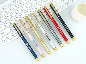 Detailed view of customized metal pens with various bank logos on a keyboard background.