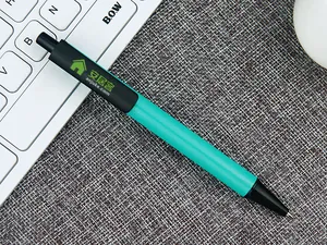 Detailed macro shot of a sleek retractable teal metal pen resting on an office desk