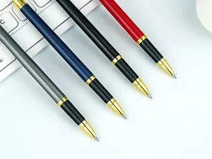 Detail view of four luxury metal ballpoint pens in grey, blue, black and red colors.