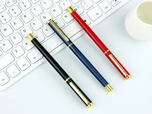 Premium metal signature pens in black, blue, and red with elegant gold clips on a white keyboard