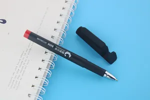 Black gel pen featuring a unique phone stand cap placed on a white spiral notebook