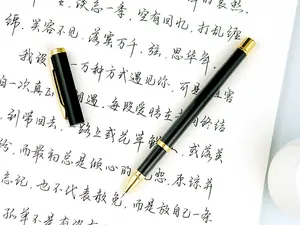 Elegant black and gold metal business signature pen on a writing paper with calligraphy
