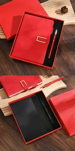 Detailed view of a premium red A5 notebook and ballpoint pen set in a luxury gift box
