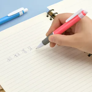 Pink and white retractable ballpoint pen 0.7mm with ergonomic grip writing on notebook page