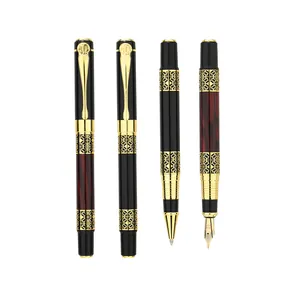 Chinese style metal fountain and rollerball pen set with gold filigree detail pattern.