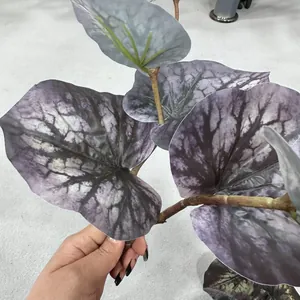 Close-up detail of artificial large begonia leaf featuring a unique purple marble pattern