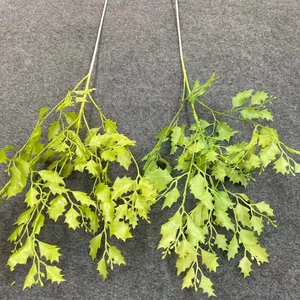 Close-up of two lifelike artificial green leaf branches for wedding hanging decorations