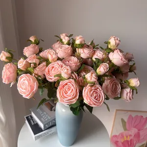 Detailed view of pink silk 3-head roses in a light blue vase for home decor.