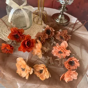 Detail of 3-head artificial peony flowers in warm autumn tones for wedding decor