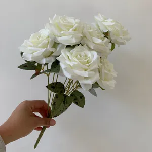 Hand-held artificial white rose bouquet with nine blooming flower heads