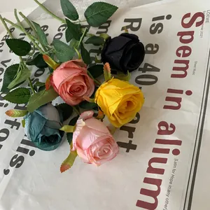 Detailed view of colorful artificial Bulgarian roses on a vintage newsprint background