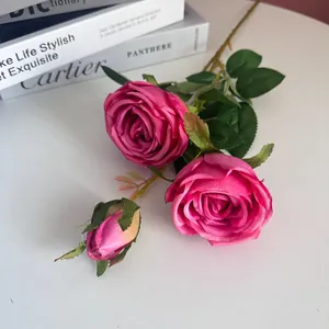 Close-up of vibrant magenta 3-headed artificial silk rose with realistic petals