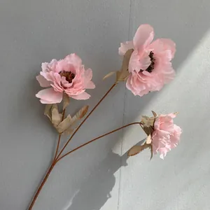 Close-up detail of a three-headed pink artificial peony flower branch for wedding decor