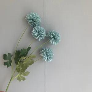 Detailed view of artificial blue-green pompon chrysanthemums for wedding and home decor
