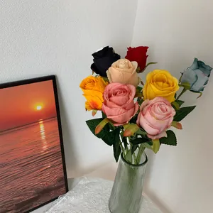 Detailed view of colorful artificial Bulgarian roses in a glass vase for home decor