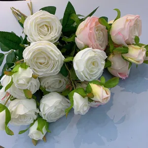 Detailed view of white and blush pink artificial silk roses bouquet for wedding decor