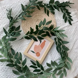Detailed view of realistic artificial willow leaf vine for home and wedding decor