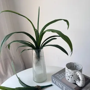 Close-up detail of realistic artificial orchid leaves for creative home floral arrangement