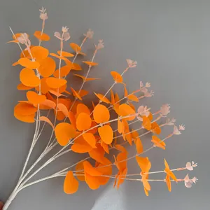 Close-up view of 16-fork artificial orange eucalyptus money leaf branches for decor